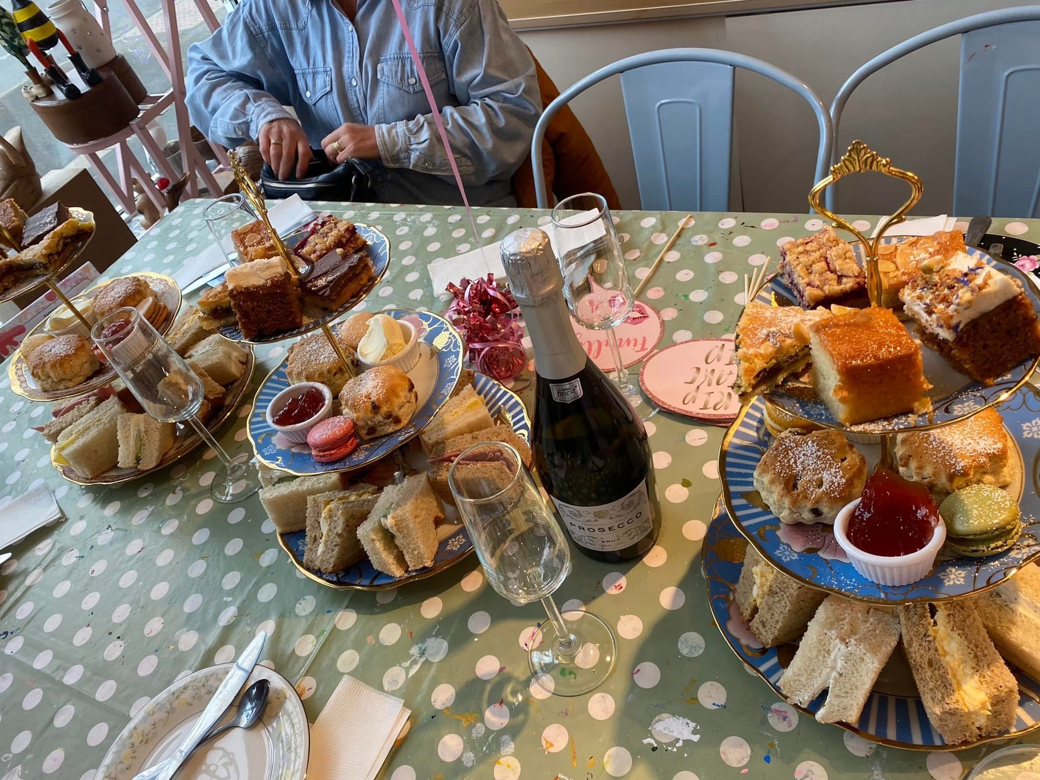 afternoon tea at arty boat exmouth, laid out on the table, on traditional afternoon tea stands, with bottle of wine
