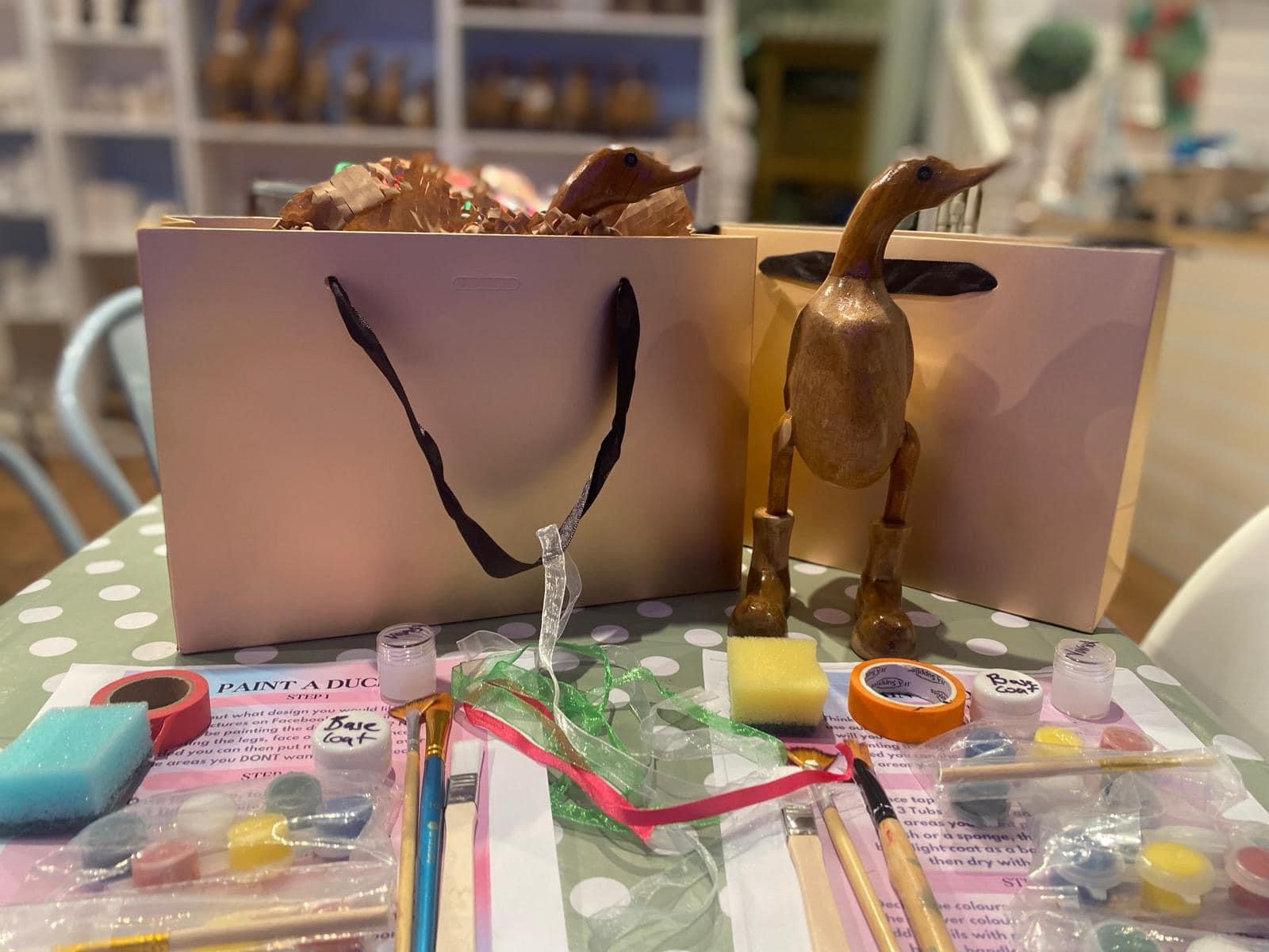 pottery painting exmouth shop Arty Boat offering a wooden duck paint at home kit in a gold coloured bag