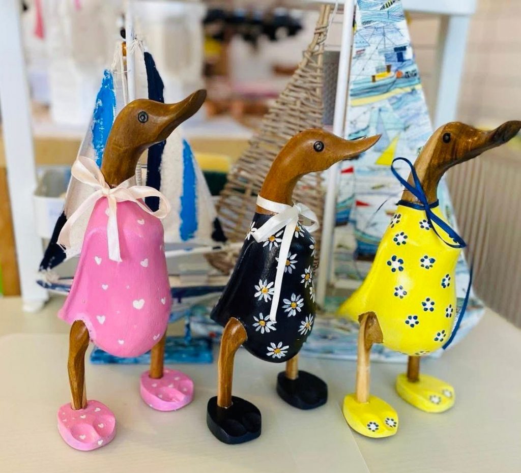 painted wooden ducks at arty boat, pink, black and yellow 