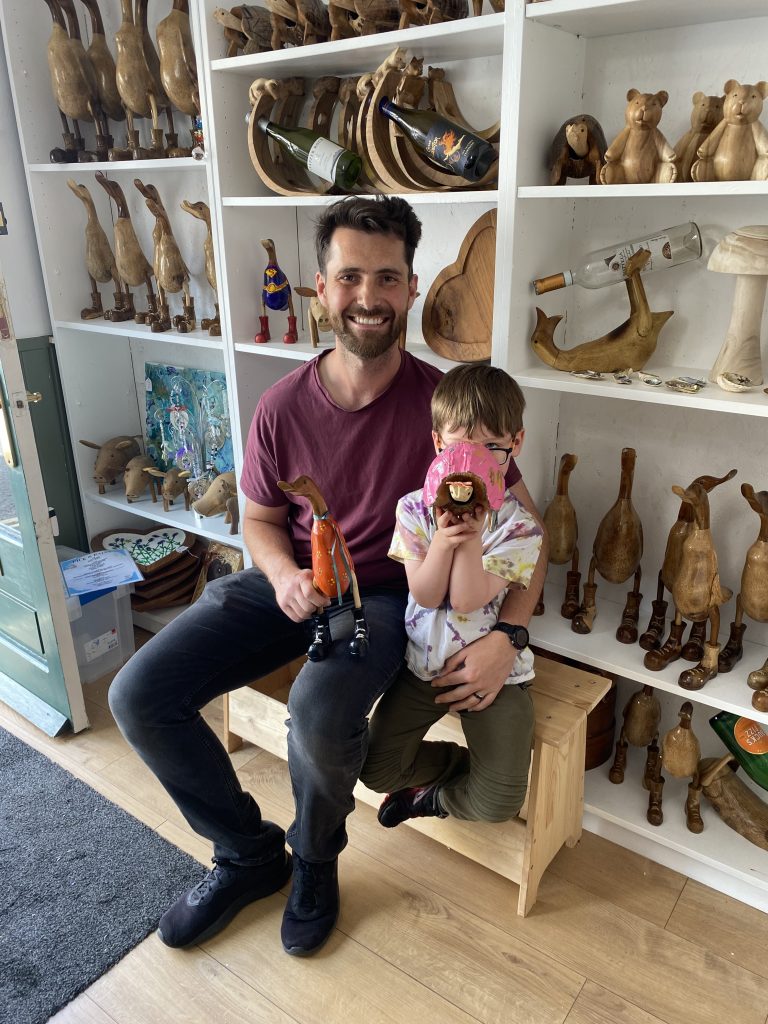 man and son inside arty boat exmouth, showing their painted wooden ducks