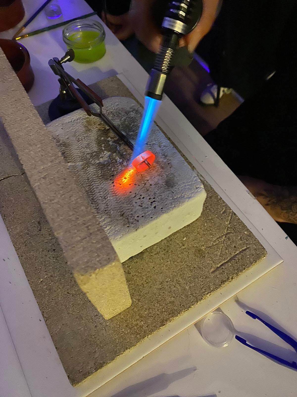 glowing blow torch being used in jewellery workshop arty boat exmouth