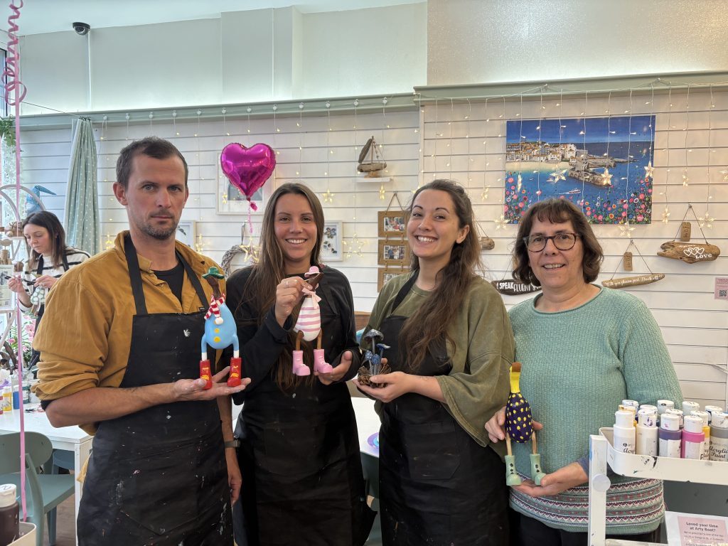 adults enjoying pottery painting and wooden duck painting on a rainy day at arty boat exmouth