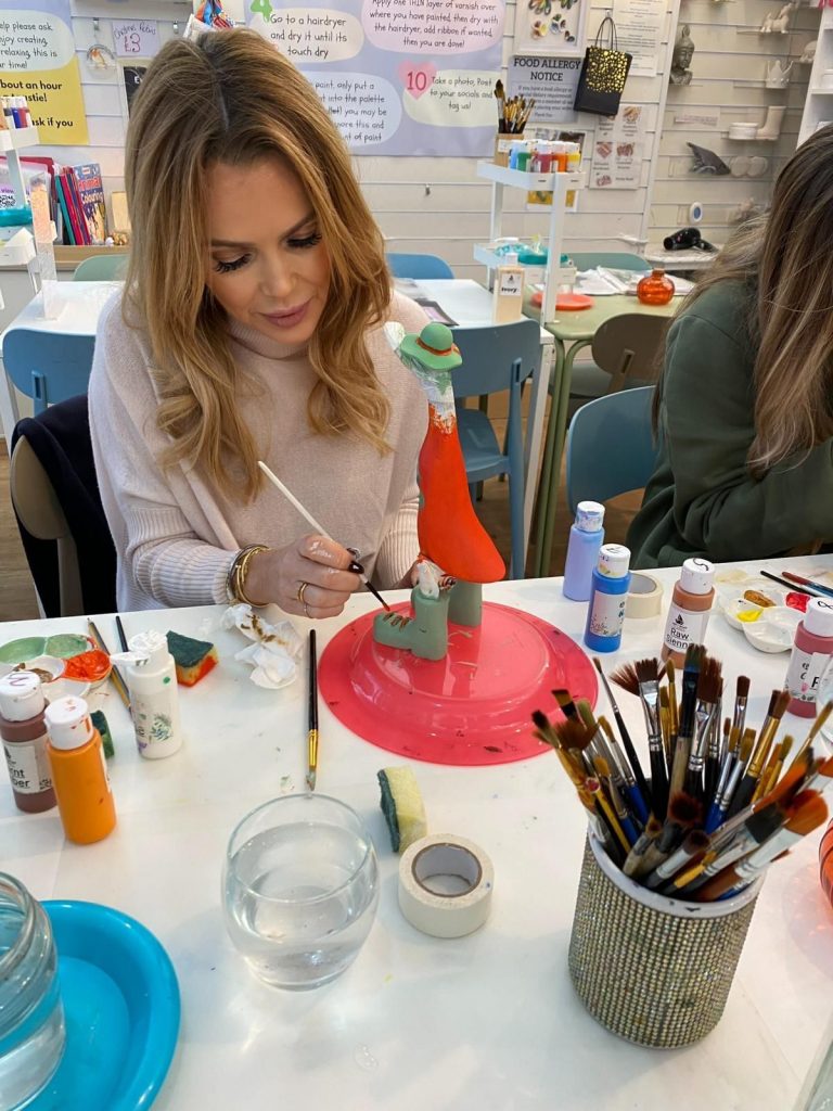 Indoor activity near Devon Cliffs – families painting pottery and wooden ducks at Arty Boat