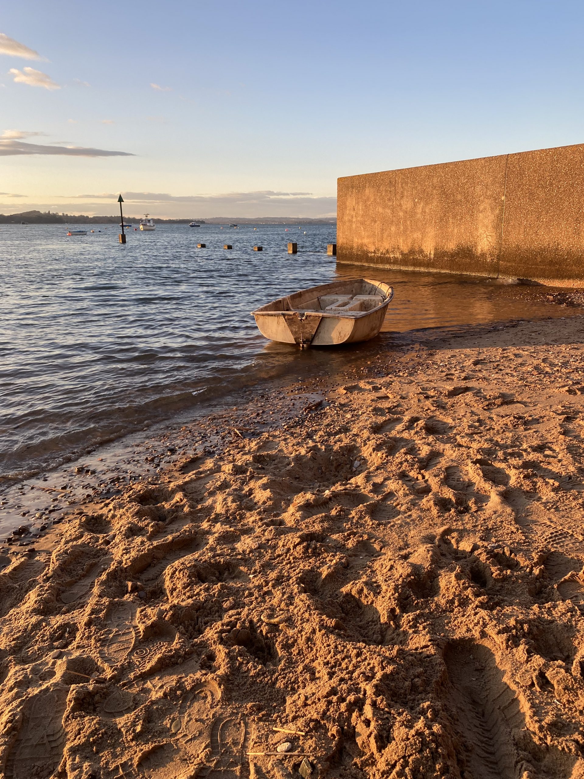 Exe Estuary Exmouth sandy shore and small boat at sunset