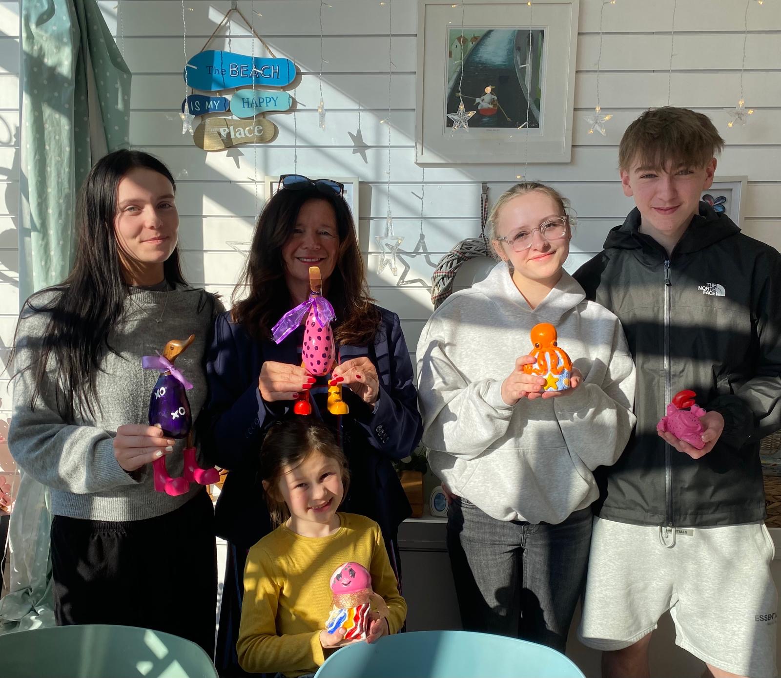 Family activity at Arty Boat in Exmouth holding painted creations