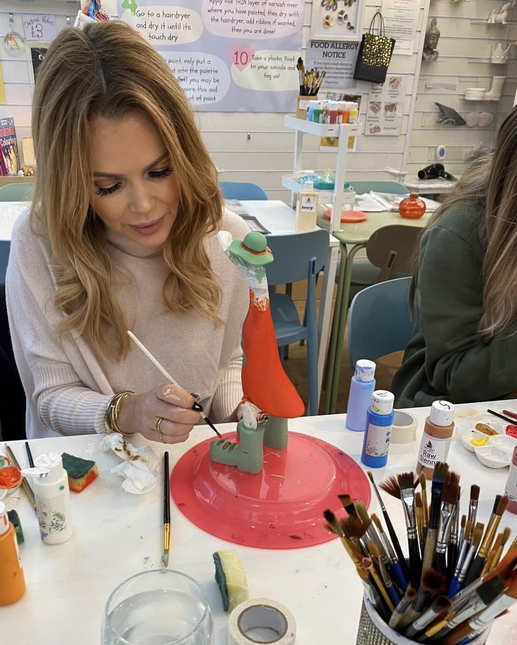 Painting a colourful wooden duck at Arty Boat creative studio in Exmouth